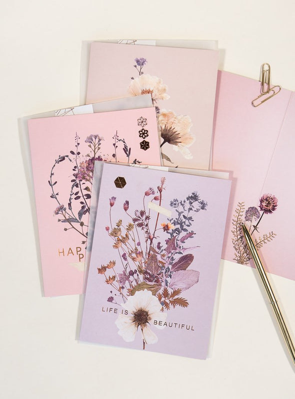 greeting cards with pen on table